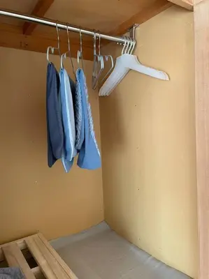 a closet with blue jackets hanging on a rack at West Kamata 5 \u897f\u84b2\u672c\u5bb6 in Tokyo