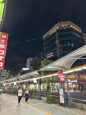 a group of people walking down a street at night at West Kamata 5 \u897f\u84b2\u672c\u5bb6 in Tokyo