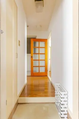 an empty hallway with a staircase and a orange door at \u7acb\u77f35\u4e01\u76eem201 in Tokyo