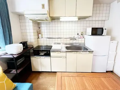 a small kitchen with a sink and a refrigerator at \u7acb\u77f35\u4e01\u76eem201 in Tokyo