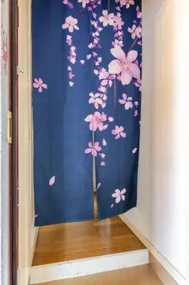 a room with a blue curtain with pink flowers at \u7acb\u77f35\u4e01\u76eem401 in Tokyo