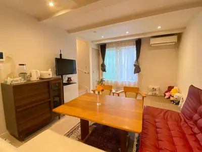 a living room with a couch and a table at \u4ec1\u6e90\u5bbf in Tokyo