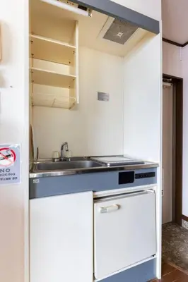 a small kitchen with a sink and a stove at \u5f25\u751f\u753a1\u4e01\u76ee202 in Tokyo