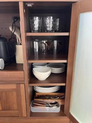 a cabinet with plates and utensils in it at \u5f25\u751f\u753a1\u4e01\u76ee206 in Tokyo