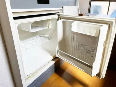 an open refrigerator with its door open and its door at \u5f25\u751f\u753a1\u4e01\u76ee206 in Tokyo