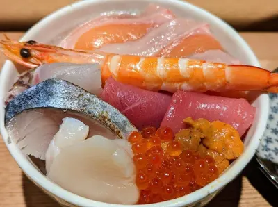 a bowl of food with fish and other foods at \u6e0b\u8c37\u30e9\u30a4\u30aa\u30f3\u30ba\u30de\u30f3\u30b7\u30e7\u30f3\u9053\u7384\u5742\u4e03 in Tokyo