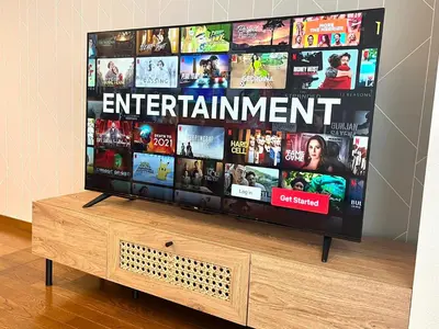 a flat screen tv sitting on top of a wooden stand at Spacious 1120feet , 3-Bedroom Apartment near Ikebukuro, 2 Minutes to Train in Tokyo