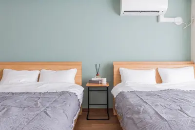 two beds sitting next to each other in a bedroom at Spacious 1120feet , 3-Bedroom Apartment near Ikebukuro, 2 Minutes to Train in Tokyo