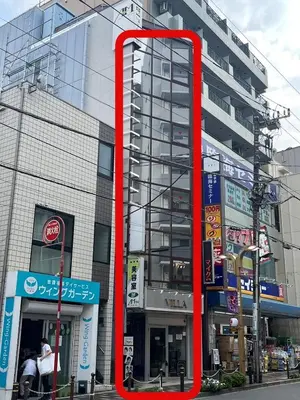 a red object is in front of a building at Spacious 1120feet , 3-Bedroom Apartment near Ikebukuro, 2 Minutes to Train in Tokyo