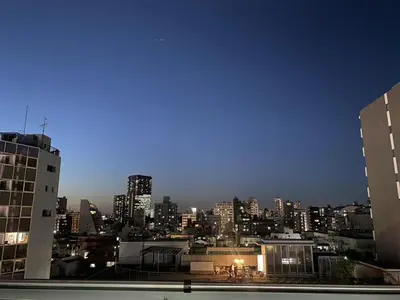 a view of a city skyline at night at Shinjuku House in Tokyo