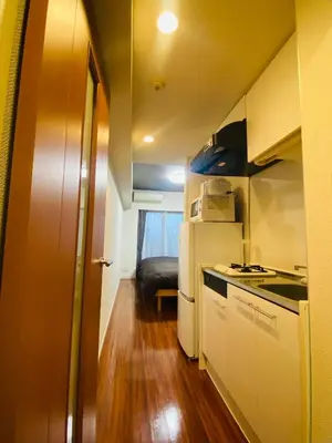 a small kitchen with a sink and a refrigerator at Shinjuku House in Tokyo