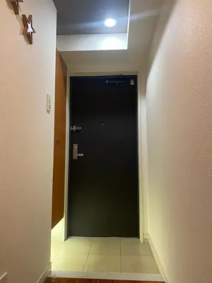 a hallway with a black door in a room at Shinjuku House in Tokyo