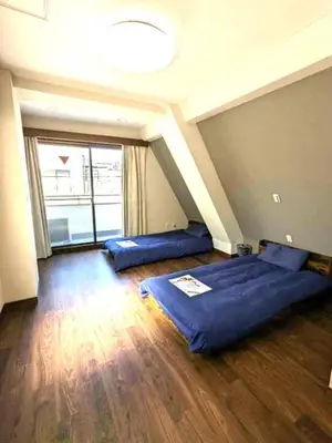 two beds in a room with a large window at Senzoku 21 - Vacation STAY 69137v in Tokyo