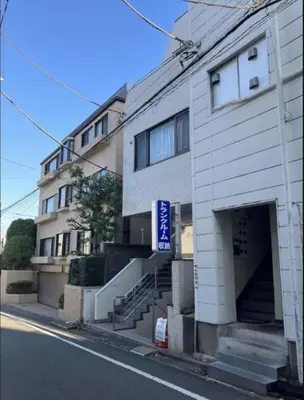 a white building with a garage on the side of a street at Senzoku 21 - Vacation STAY 69137v in Tokyo