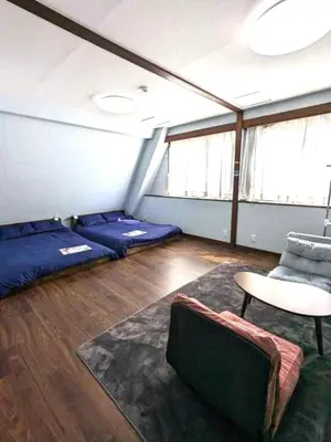 a room with beds and a table and a chair at Senzoku 21 - Vacation STAY 69137v in Tokyo