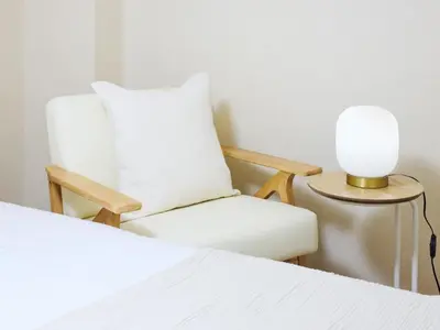 a white chair and a table with a lamp at tokyo Japandi apartment ikebukuro in Tokyo