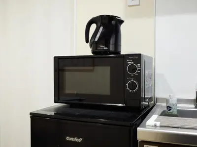 a microwave with a coffee pot on top of it at tokyo Japandi apartment ikebukuro in Tokyo
