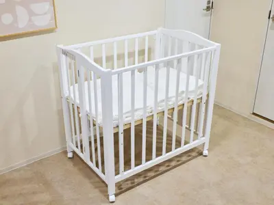 a white crib sitting in a room at tokyo Japandi apartment ikebukuro in Tokyo