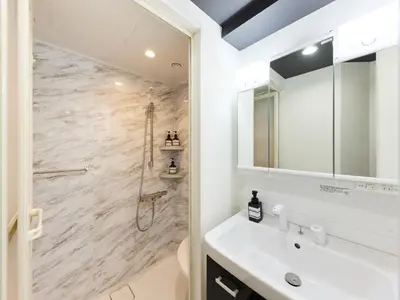 a bathroom with a shower and a white sink at tokyo Japandi apartment ikebukuro in Tokyo
