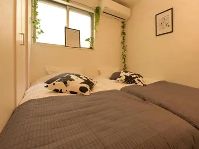 two beds in a small room with a window at Sugamototate - Vacation STAY 50637v in Tokyo