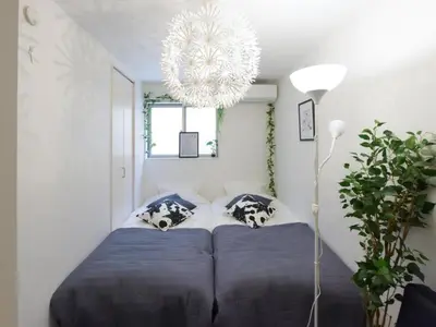 a bedroom with a bed and a chandelier at Sugamototate - Vacation STAY 50637v in Tokyo