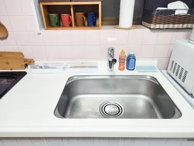 a kitchen sink in a white counter top at TK House Tokyo Ikebukuro Max5PPL in Tokyo