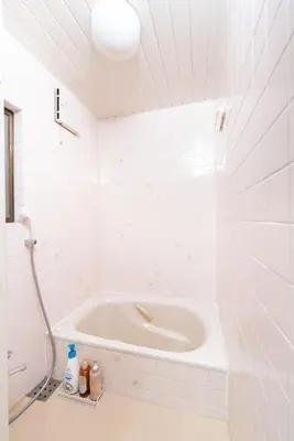 a white bath tub in a white tiled bathroom at TK House Tokyo Ikebukuro Max5PPL in Tokyo