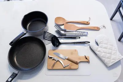 a bunch of utensils on a table with a pan and spatula at TK House Tokyo Ikebukuro Max5PPL in Tokyo
