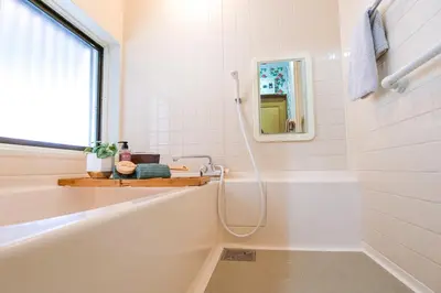 a white bathroom with a tub and a sink at Urayasu Villa in Tokyo