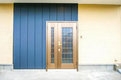 a door to a building with a blue wall at Urayasu Villa in Tokyo