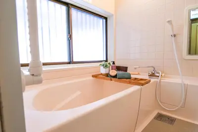 a white bath tub in a bathroom with a window at Urayasu Villa in Tokyo
