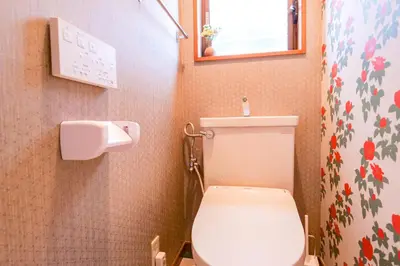 a bathroom with a toilet and a toilet paper dispenser at Urayasu Villa in Tokyo