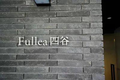 a sign on the side of a brick wall at Fullea Yotsuya in Tokyo