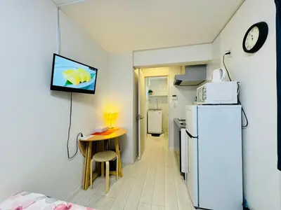 a small kitchen with a small table and a refrigerator at Real Waseda SJ0261 in Tokyo