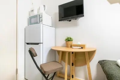 a small room with a small table and a refrigerator at Real Waseda SJ0261 in Tokyo