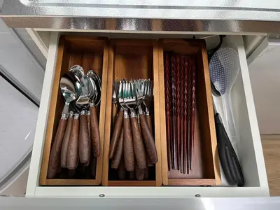a wooden drawer with utensils in a kitchen at \u5f25\u751f\u753a1\u4e01\u76ee\u6238\u5efa in Tokyo