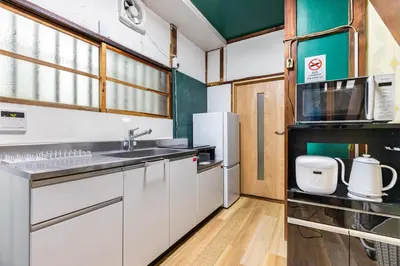 a kitchen with white cabinets and a sink at \u5f25\u751f\u753a1\u4e01\u76ee\u6238\u5efa in Tokyo