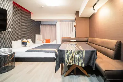 a hotel room with a bed and a couch at \u79cb\u53f6\u539f\u5609\u967d\u30d3\u30eb in Tokyo