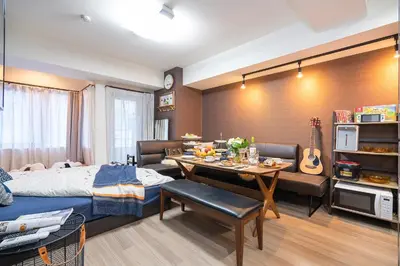 a bedroom with a bed and a table with food on it at \u79cb\u53f6\u539f\u5609\u967d\u30d3\u30eb in Tokyo