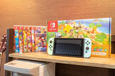 a microwave sitting on a shelf next to some games at \u79cb\u53f6\u539f\u5609\u967d\u30d3\u30eb in Tokyo