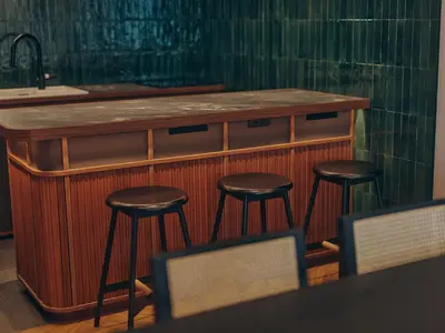 a bar with three stools at a counter with a sink at illi Surp Shiba-Park in Tokyo