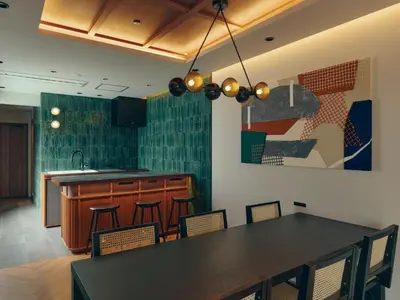 a kitchen with a black table and chairs and a counter at illi Surp Shiba-Park in Tokyo