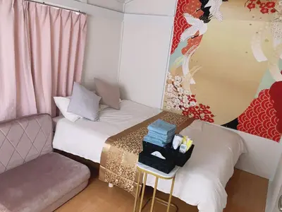 a small room with a bed and a chair at B & K Nakanosakaue in Tokyo