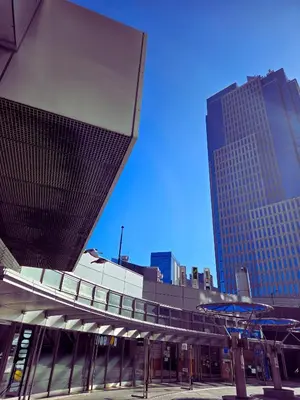 a building with a walkway in a city with tall buildings at B & K Nakanosakaue in Tokyo