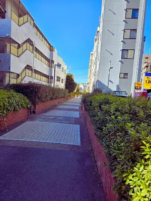 a sidewalk in a city with tall buildings at B & K Nakanosakaue in Tokyo