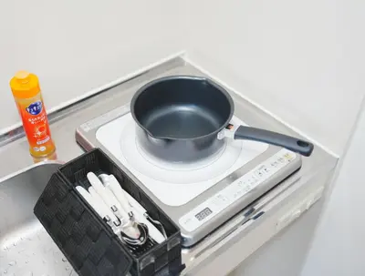 a cup sitting on a stove in a refrigerator at \u6771\u4eac\u30ea\u30ea\u30a2\u30eb\u30db\u30c6\u30eb501 in Tokyo