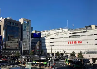 a large building with a tzilla sign on it in a city at \u590f\u7f8e\u30db\u30c6\u30eb in Tokyo