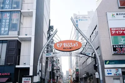 a sign in the middle of a street with buildings at \u590f\u7f8e\u30db\u30c6\u30eb in Tokyo