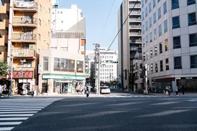 a city street with a crosswalk with buildings at \u590f\u7f8e\u30db\u30c6\u30eb in Tokyo