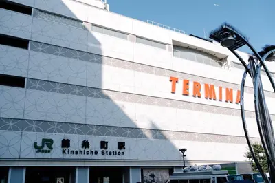 a tall white building with an orange sign on it at \u590f\u7f8e\u30db\u30c6\u30eb in Tokyo